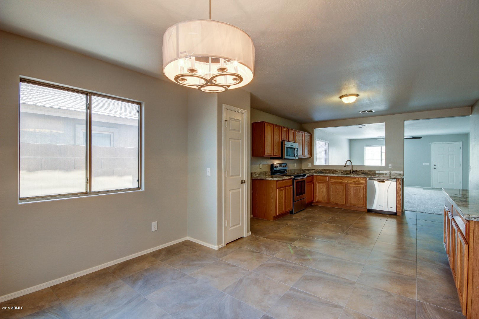 16148 West Boca Raton Road Surprise, AZ 85379 - Photo 6 of 24 a view of a kitchen and a chandelier fan