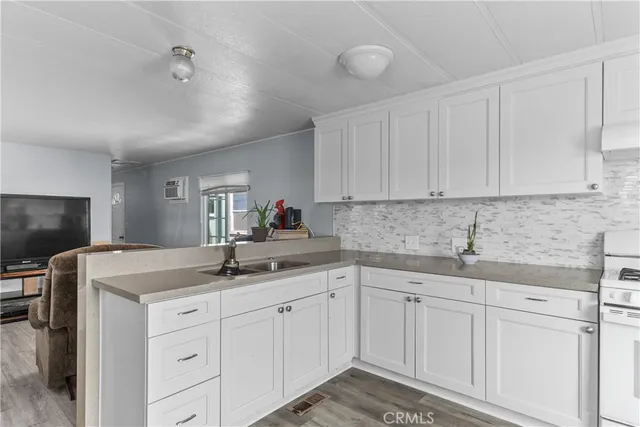a kitchen with white cabinets sink and white appliances