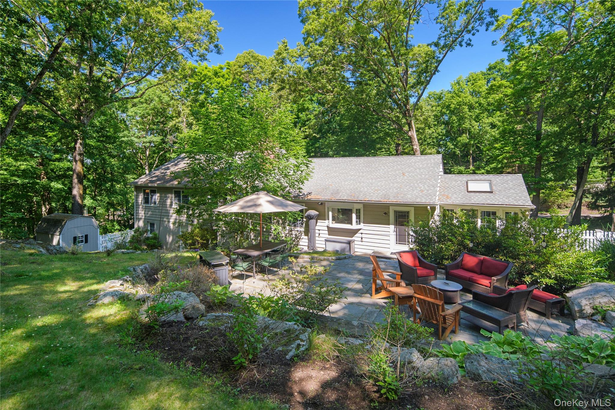 105 Cross Ridge Road Chappaqua, NY 10514 - Photo 4 of 43 The bilevel bluestone patio with firepit is accessible from the main living level and finished lower level