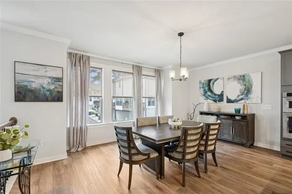 a view of a dining room with furniture window and wooden floor