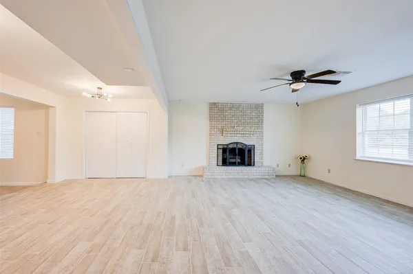 wooden floor in an empty room with a fireplace