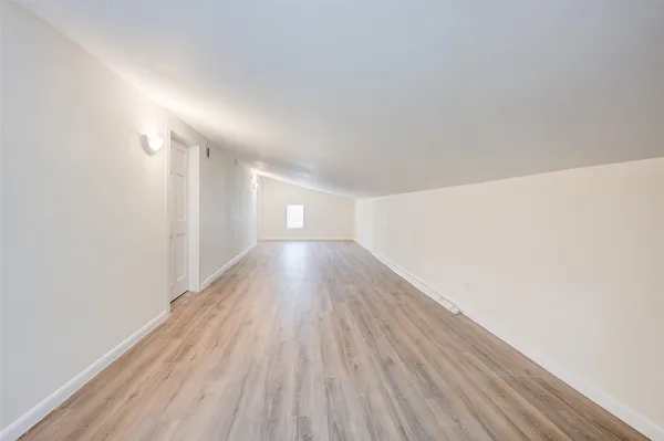 a view of a room with wooden floor
