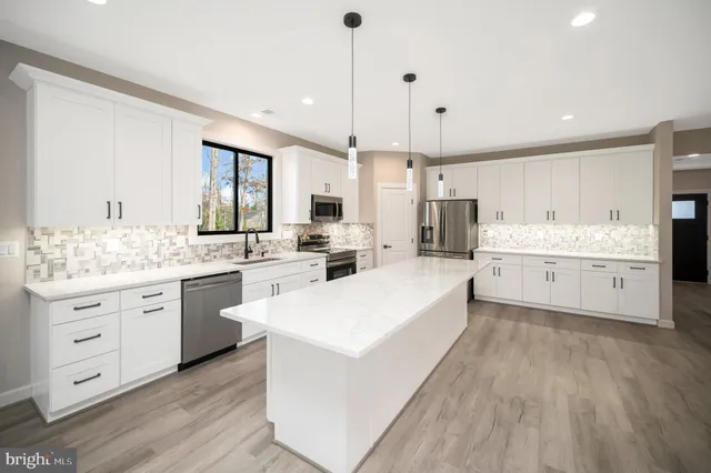 a kitchen with a sink stove and microwave