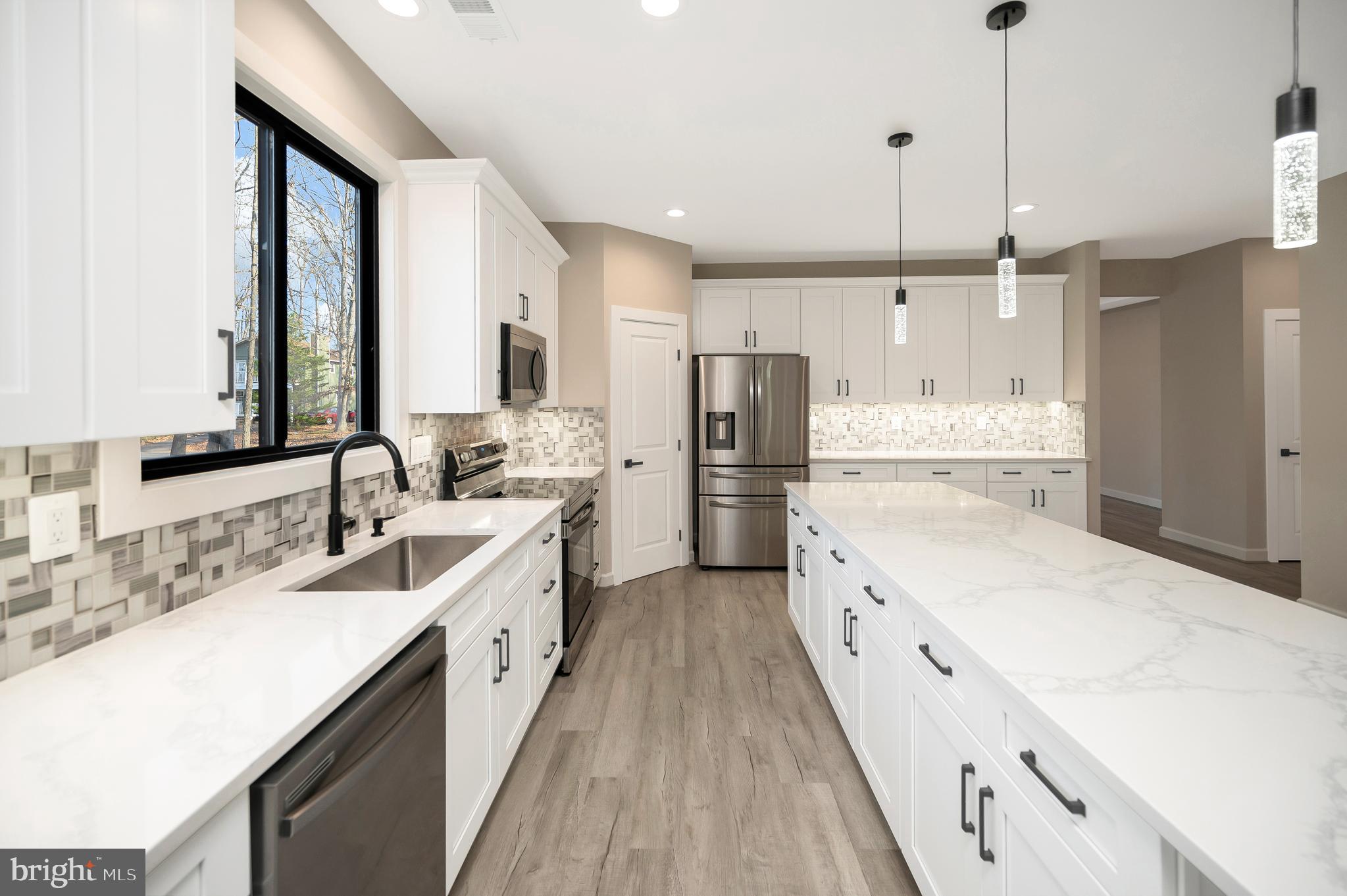 430 Liberty Boulevard Locust Grove, VA 22508 - Photo 19 of 66 a large kitchen with a large counter top a stove a sink a refrigerator and a center island