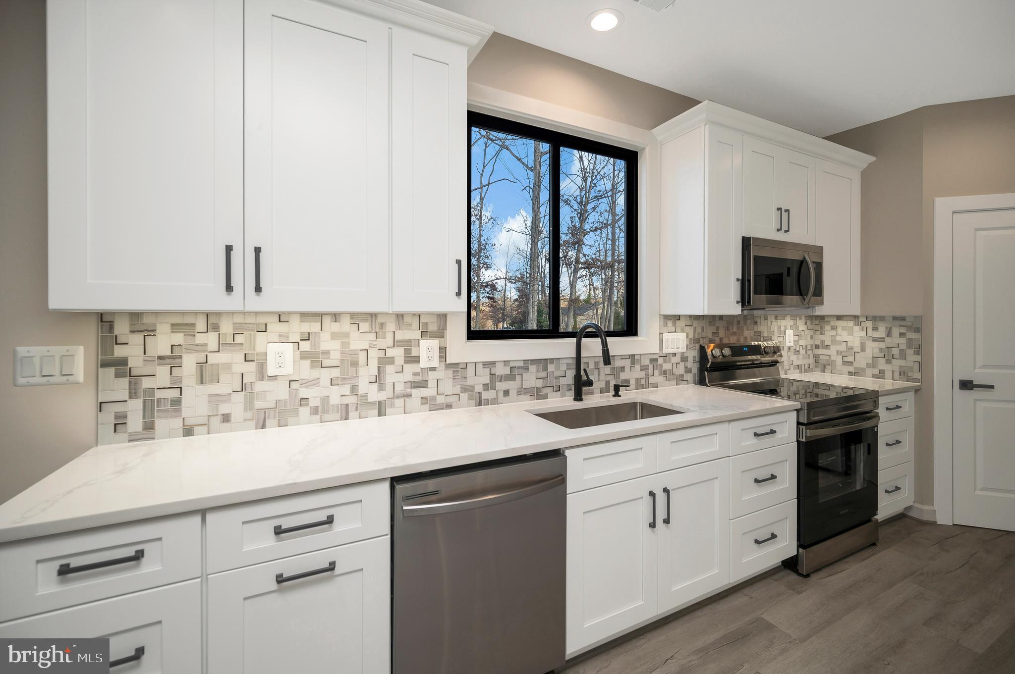430 Liberty Boulevard Locust Grove, VA 22508 - Photo 21 of 66 a kitchen with a sink stove and microwave