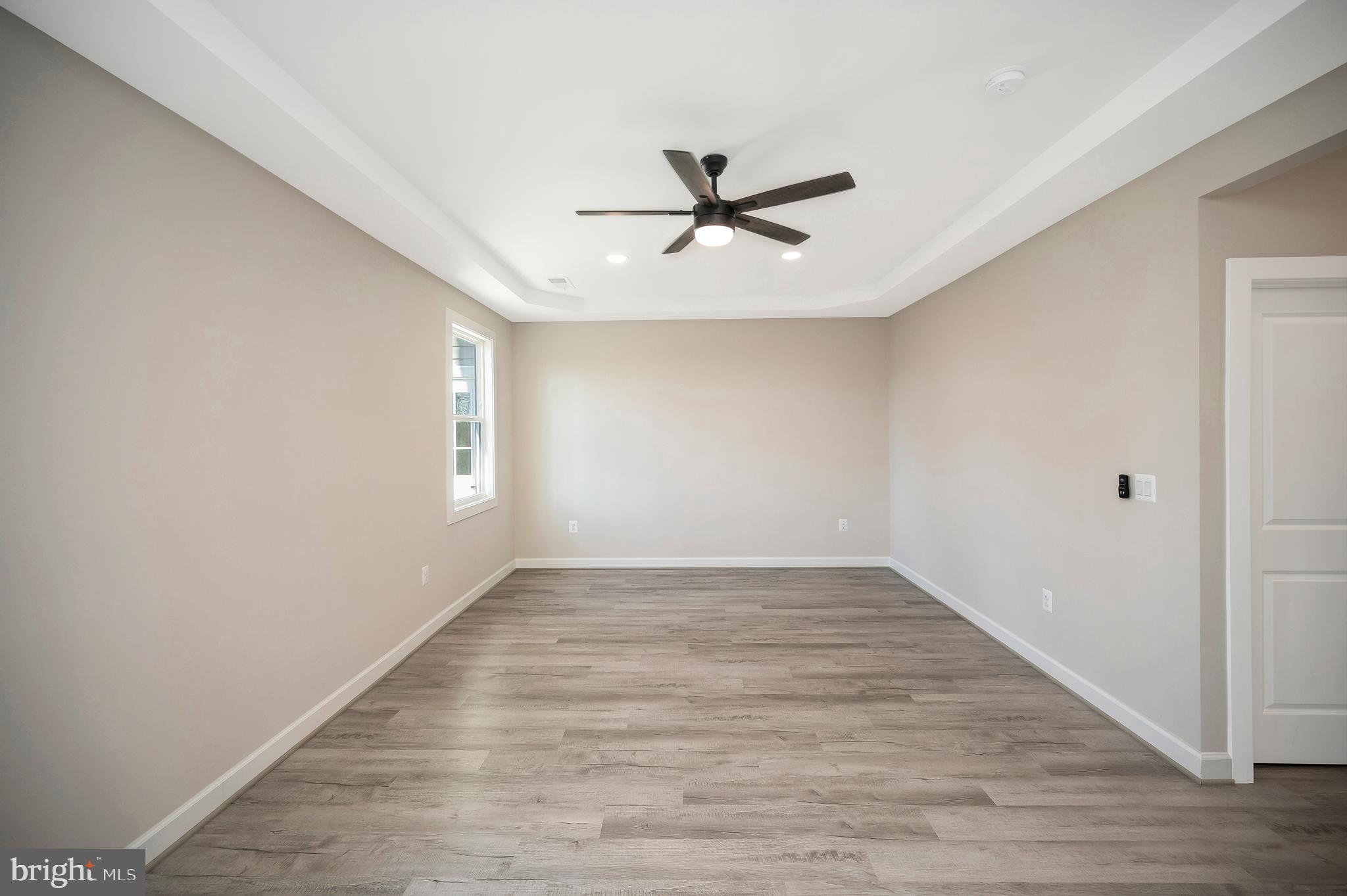 430 Liberty Boulevard Locust Grove, VA 22508 - Photo 36 of 66 an empty room with wooden floor fan and windows