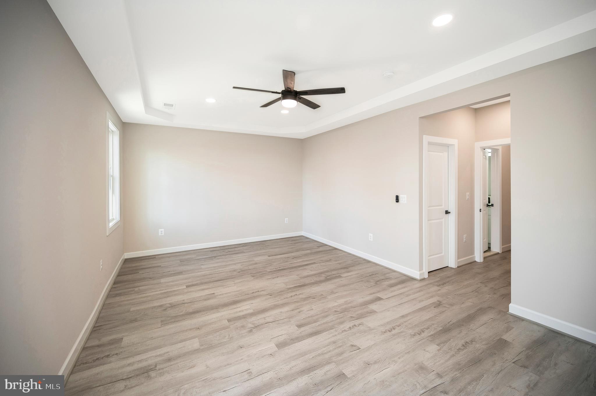 430 Liberty Boulevard Locust Grove, VA 22508 - Photo 37 of 66 an empty room with wooden floor ceiling fan and windows