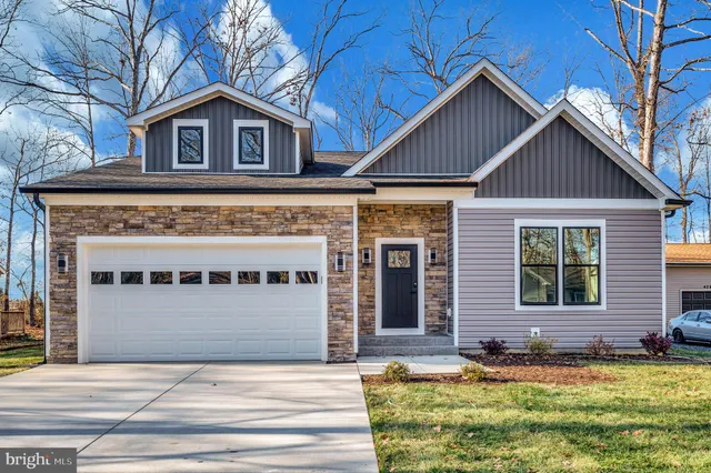 a view of house with yard and front view of house