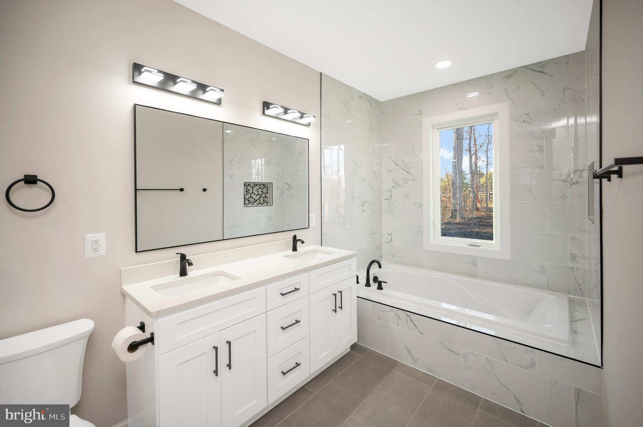 430 Liberty Boulevard Locust Grove, VA 22508 - Photo 41 of 66 a bathroom with a double vanity sink mirror double vanity and bathtub
