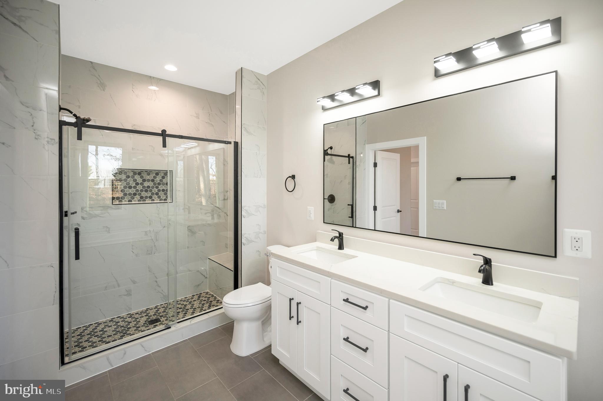 430 Liberty Boulevard Locust Grove, VA 22508 - Photo 42 of 66 a bathroom with a double vanity sink toilet mirror and shower