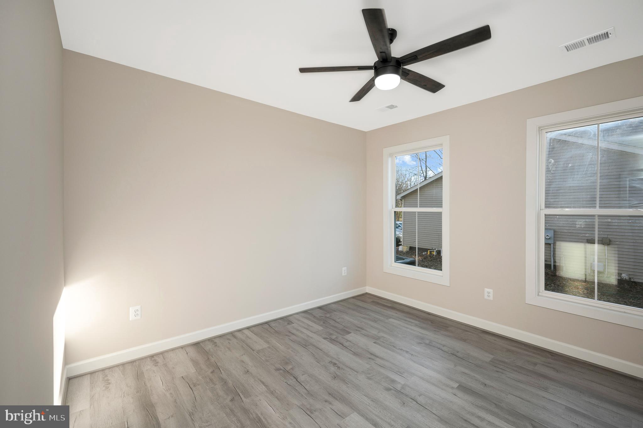 430 Liberty Boulevard Locust Grove, VA 22508 - Photo 43 of 66 an empty room with wooden floor ceiling fan and windows
