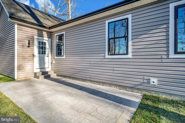 a view of a pathway of a house with a yard
