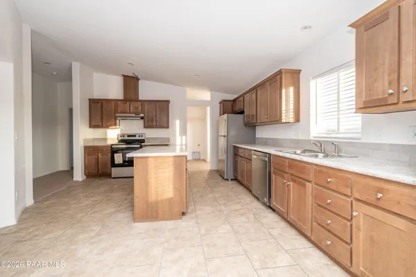 a kitchen with stainless steel appliances granite countertop a stove top oven a sink and dishwasher