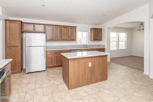a kitchen with cabinets a refrigerator and a sink
