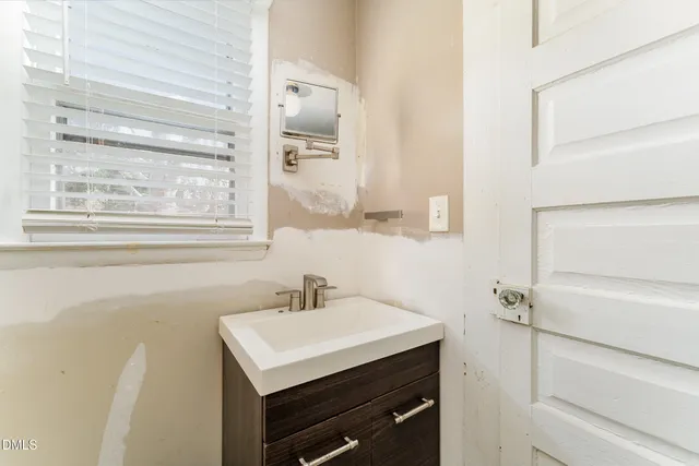 a bathroom with a sink vanity and a mirror