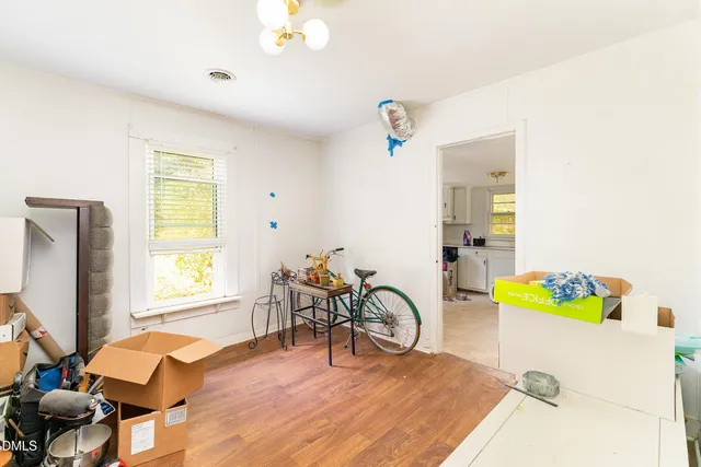 a bedroom with furniture and a wooden floor