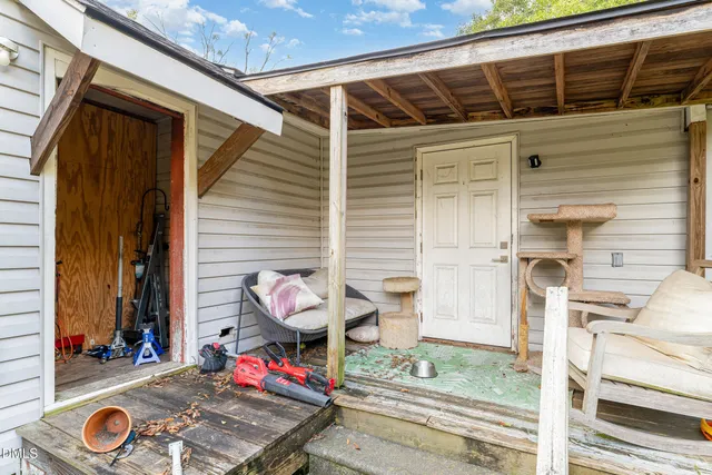 a view of a backyard with a chair and a tree