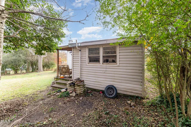a view of a backyard with table and chairs and a fire pit