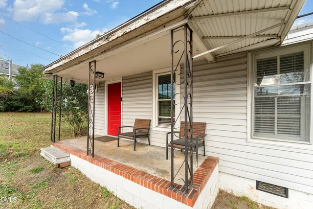 a view of a patio with a table and chairs