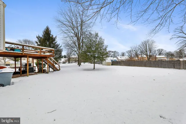 a view of city street with snow and trees
