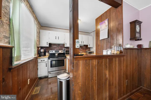a kitchen with stainless steel appliances a sink a stove and a refrigerator