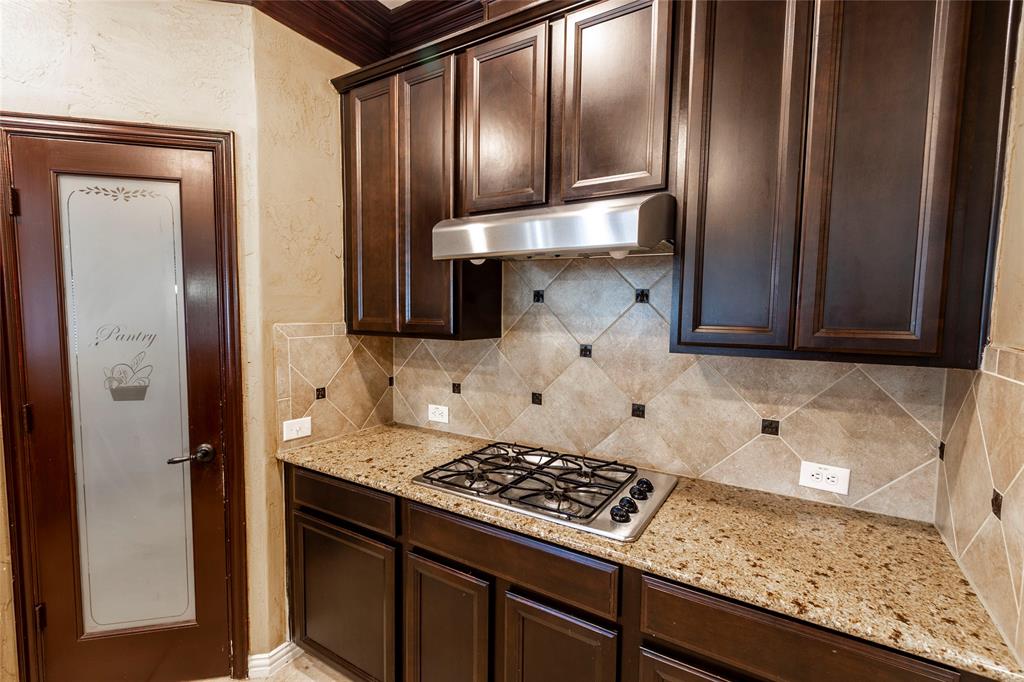 2931 Bandera Grand Prairie, TX 75054 - Photo 12 of 34 a kitchen with granite countertop a stove and a refrigerator