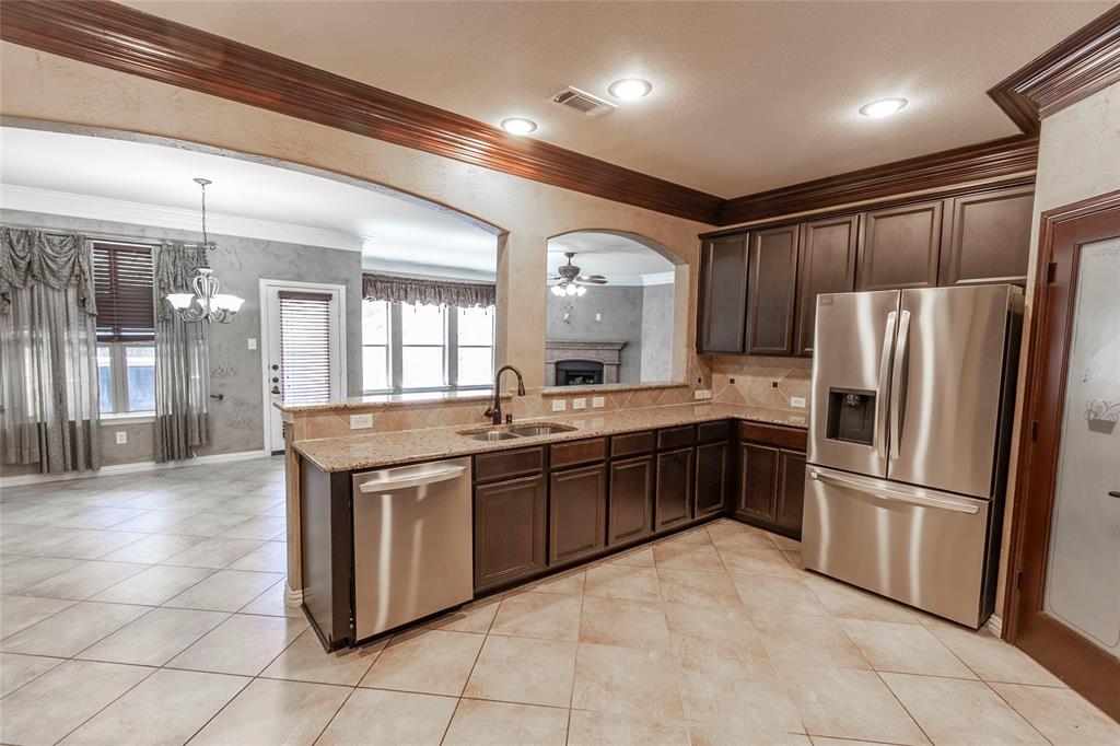 2931 Bandera Grand Prairie, TX 75054 - Photo 14 of 34 a large kitchen with stainless steel appliances granite countertop a refrigerator and a sink