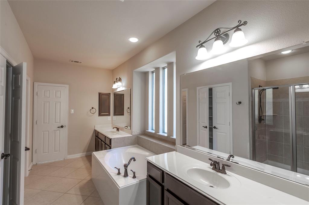 2931 Bandera Grand Prairie, TX 75054 - Photo 20 of 34 a bathroom with a sink double vanity granite tub shower and a mirror