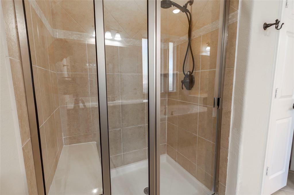 2931 Bandera Grand Prairie, TX 75054 - Photo 21 of 34 a bathroom with a glass shower door