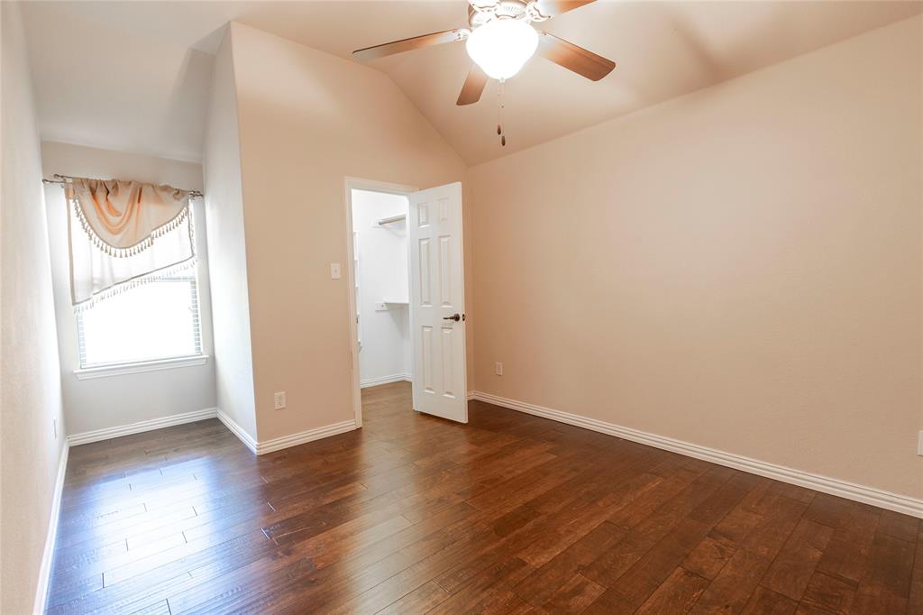 2931 Bandera Grand Prairie, TX 75054 - Photo 27 of 34 an empty room with wooden floor and windows