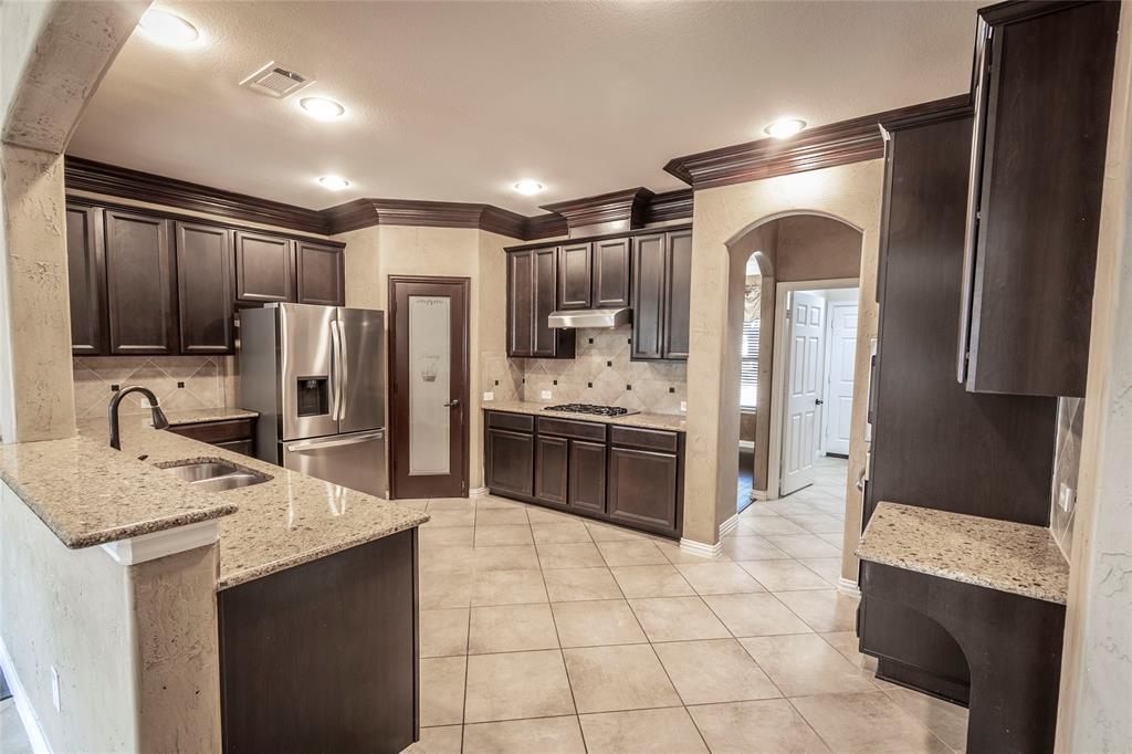 2931 Bandera Grand Prairie, TX 75054 - Photo 10 of 34 a kitchen with stainless steel appliances a sink stove refrigerator and cabinets