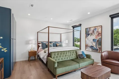 a bedroom with a bed couch and a window
