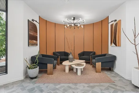 a living room with patio furniture and a potted plant