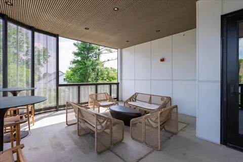a living room with furniture and a floor to ceiling window