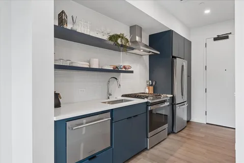 a kitchen with stainless steel appliances a sink and a stove