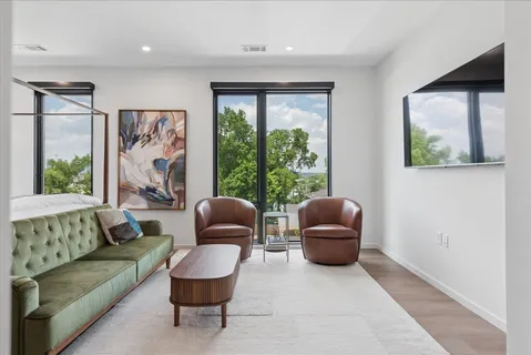 a living room with furniture and a large window