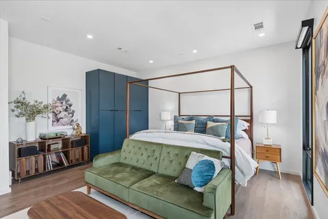 a bedroom with a bed and wooden floor
