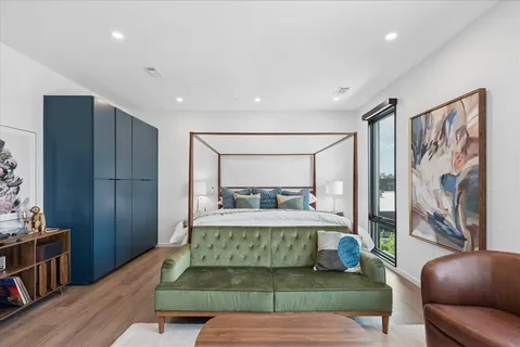 a living room with a bed furniture and a large window