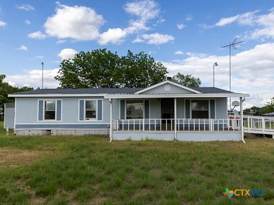 7805 Barbarosa Road New Braunfels, TX 78130 - Photo 2 of 24 a front view of a house with a garden