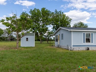 7805 Barbarosa Road New Braunfels, TX 78130 - Photo 8 of 24 a view of an house with backyard space and garden