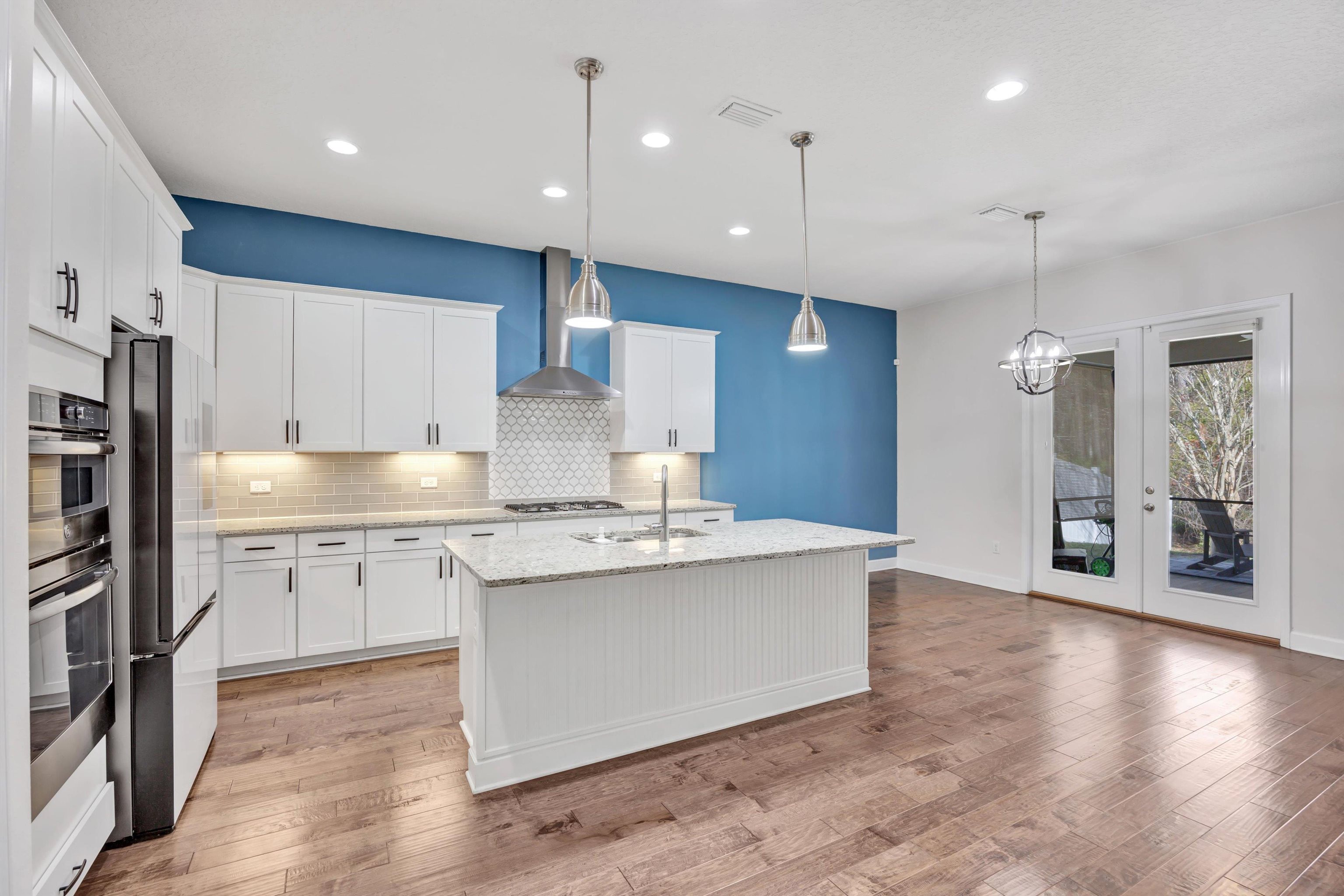 267 Downs Corner Road St. Augustine, FL 32092 - Photo 14 of 37 a kitchen with stainless steel appliances granite countertop a sink a stove and a refrigerator