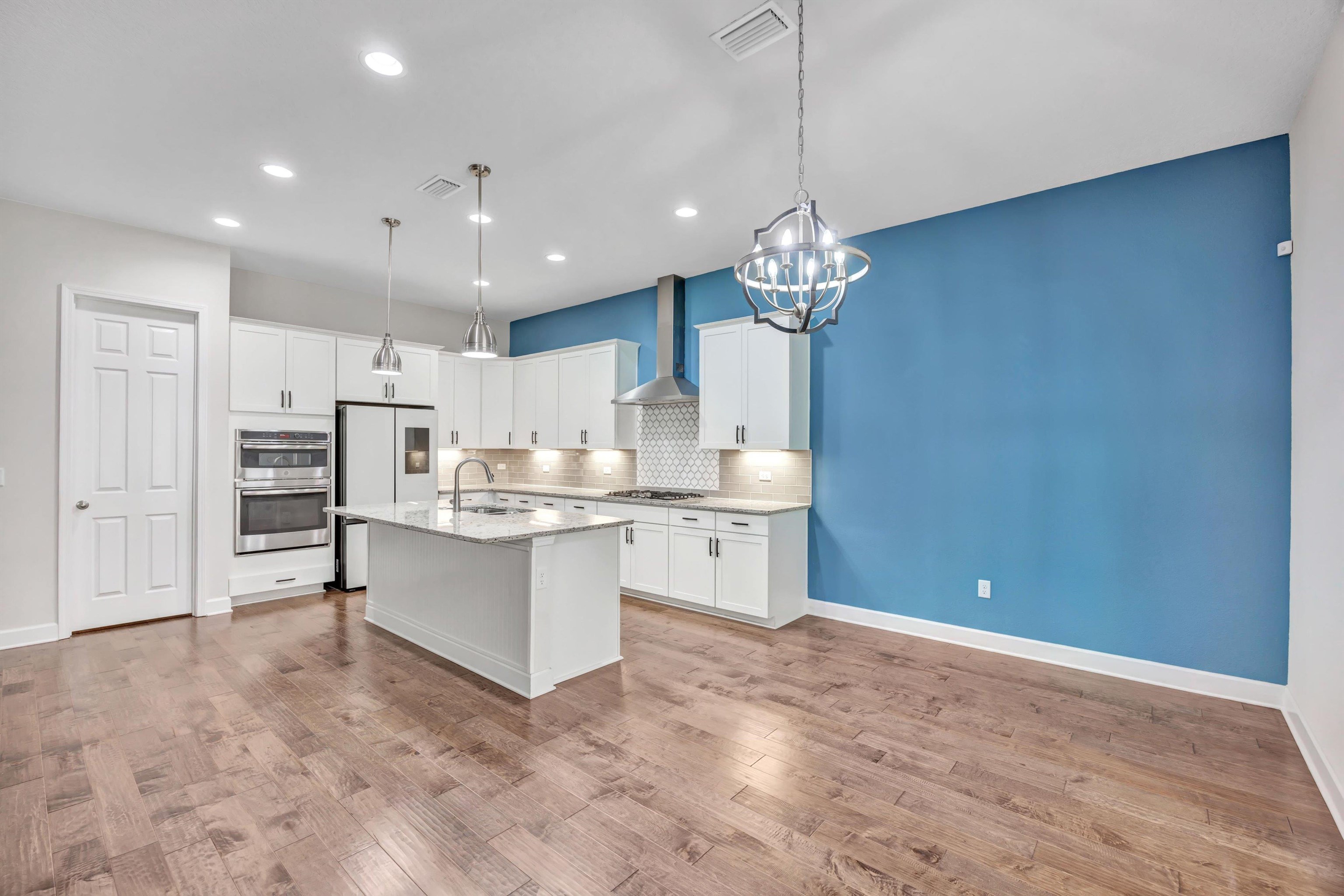 267 Downs Corner Road St. Augustine, FL 32092 - Photo 15 of 37 a large kitchen with kitchen island white cabinets and stainless steel appliances