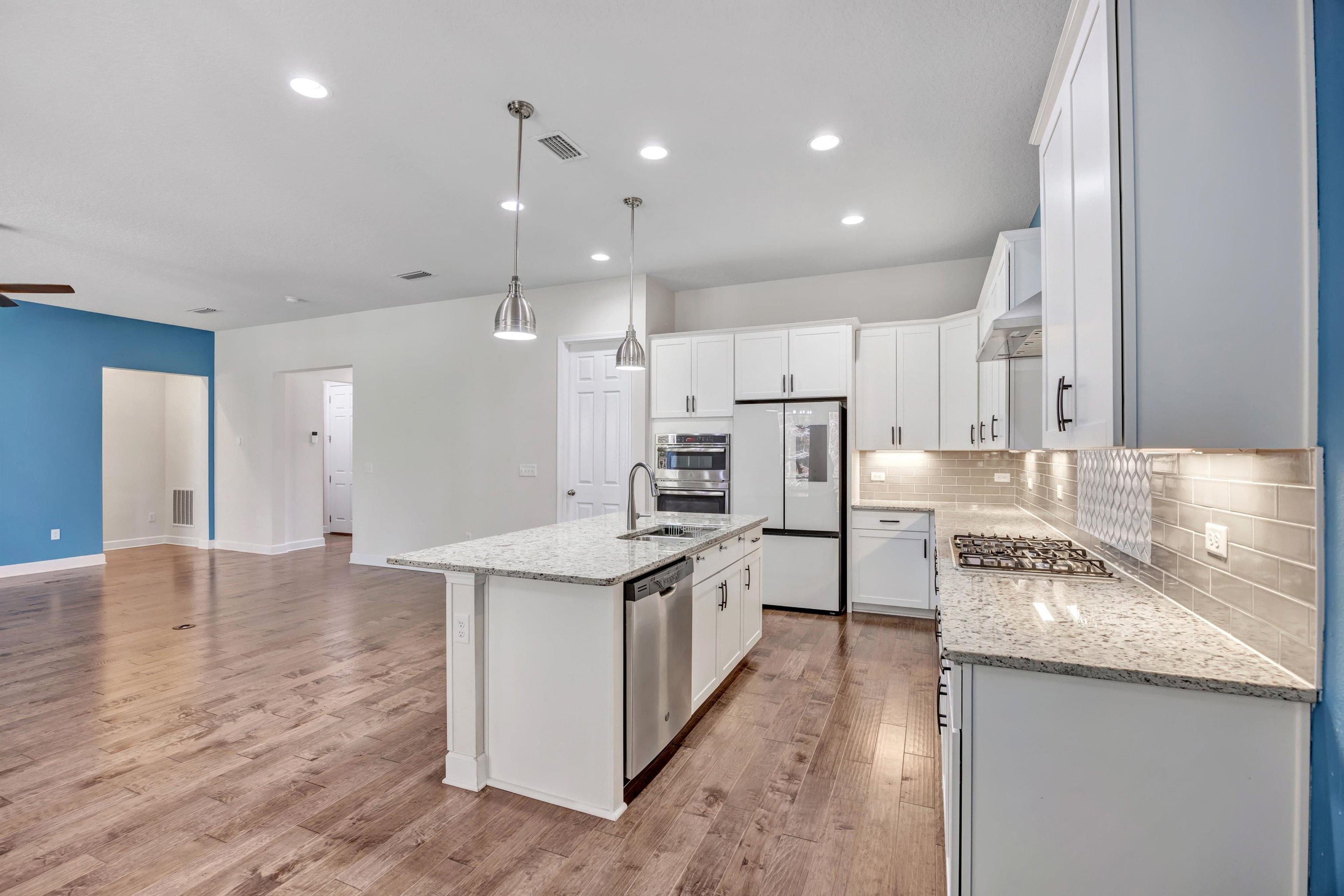 267 Downs Corner Road St. Augustine, FL 32092 - Photo 16 of 37 a kitchen with stainless steel appliances granite countertop a sink stove and refrigerator