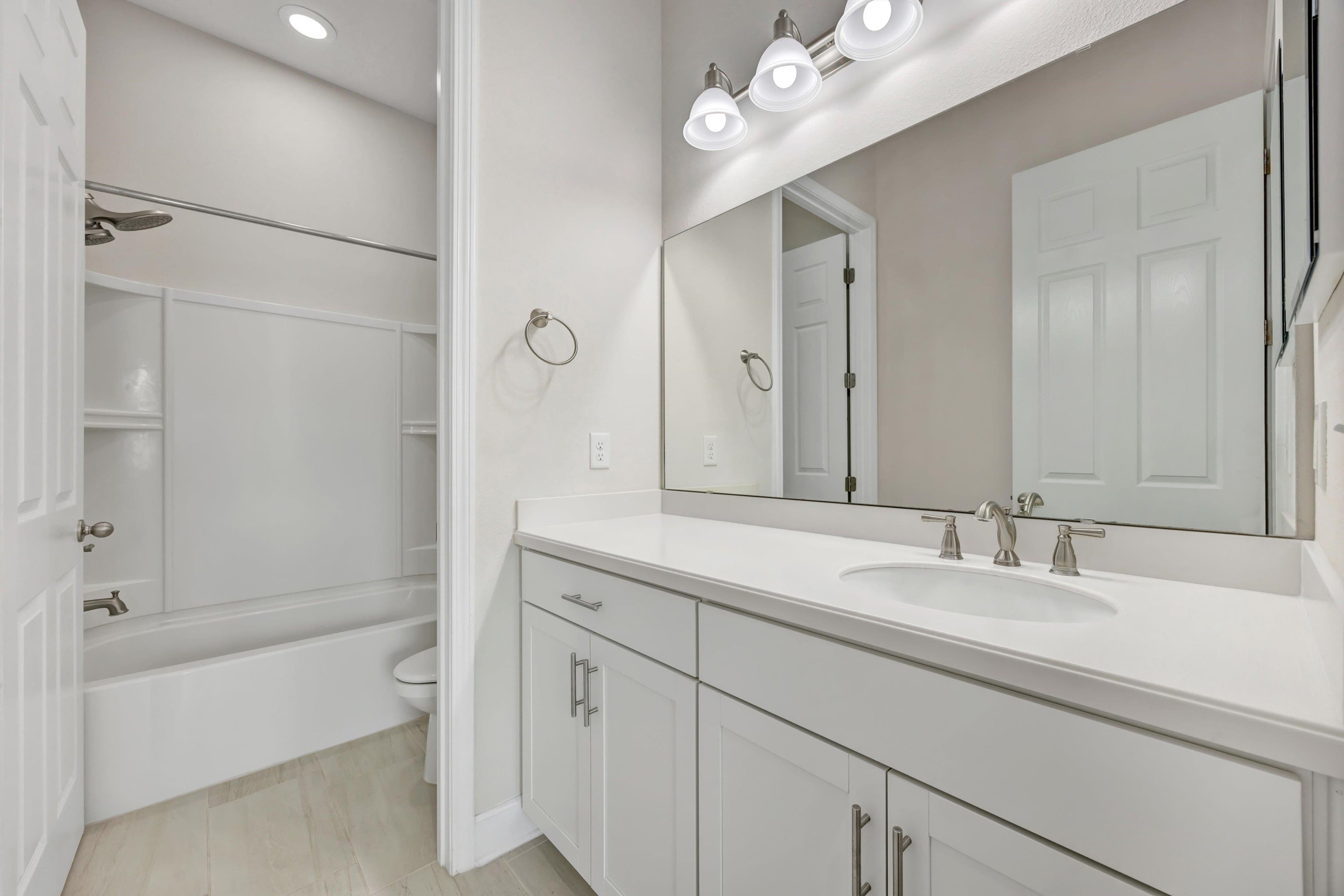 267 Downs Corner Road St. Augustine, FL 32092 - Photo 29 of 37 a bathroom with a bathtub shower sink vanity and mirror