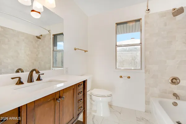 a bathroom with a sink vanity and a mirror