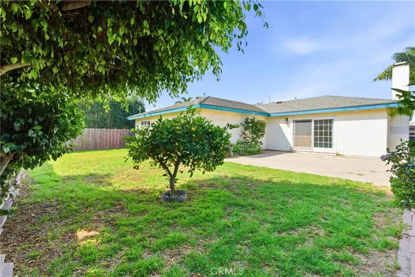 a view of house with backyard
