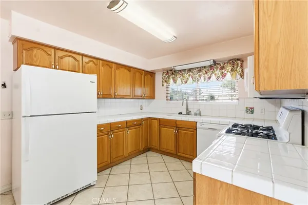 a kitchen with stainless steel appliances granite countertop a refrigerator sink and cabinets