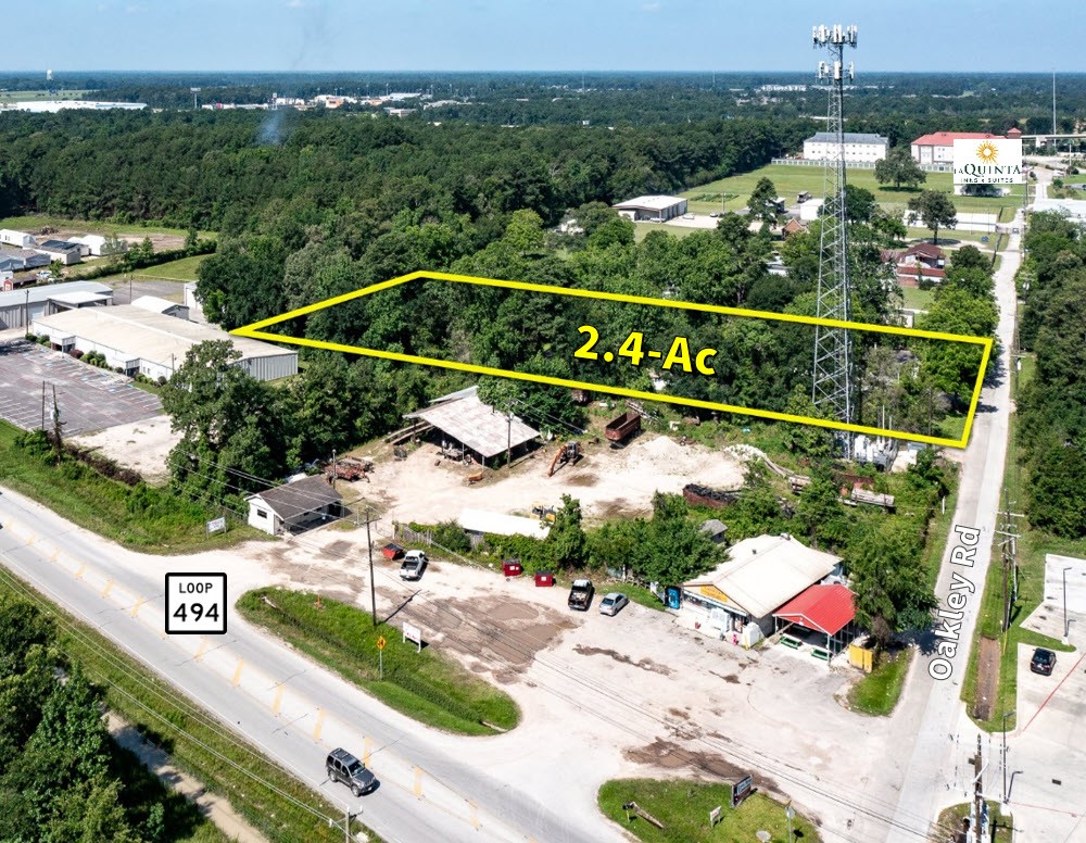 22688 Oakley Road New Caney, TX 77357 - Photo 2 of 11 an aerial view of a house with a garden and lake view
