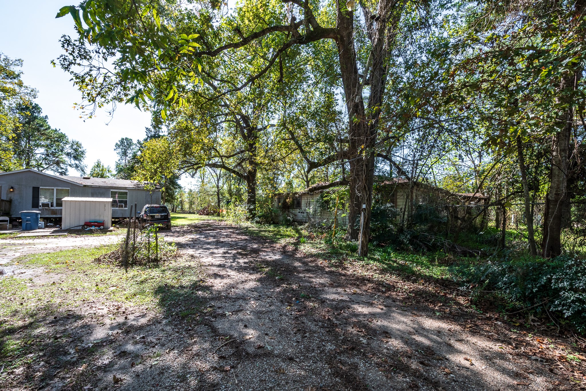 22688 Oakley Road New Caney, TX 77357 - Photo 7 of 11 a view of a backyard with table and chairs and a large tree