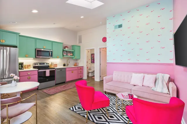 a living room with stainless steel appliances furniture and a couch